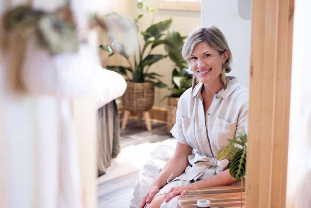 Owner of the big sky spa Sanctuary sitting in one of the facial room spaces