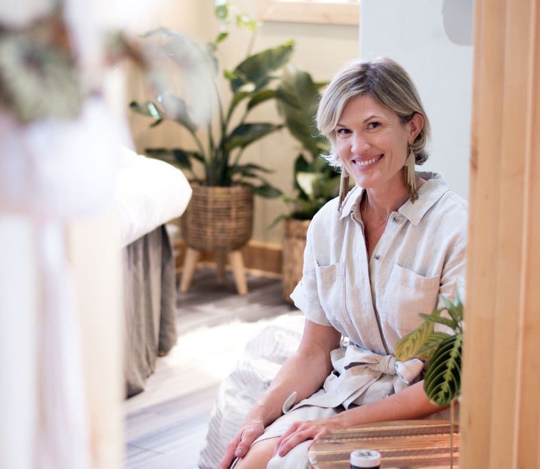 Owner of the big sky spa Sanctuary sitting in one of the facial room spaces