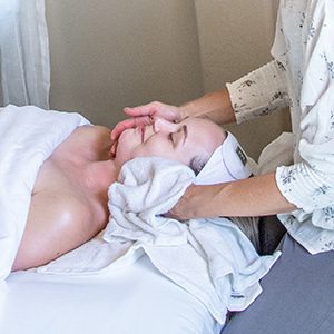 Hot towel wrapped around client's face at spa in Big Sky Montana